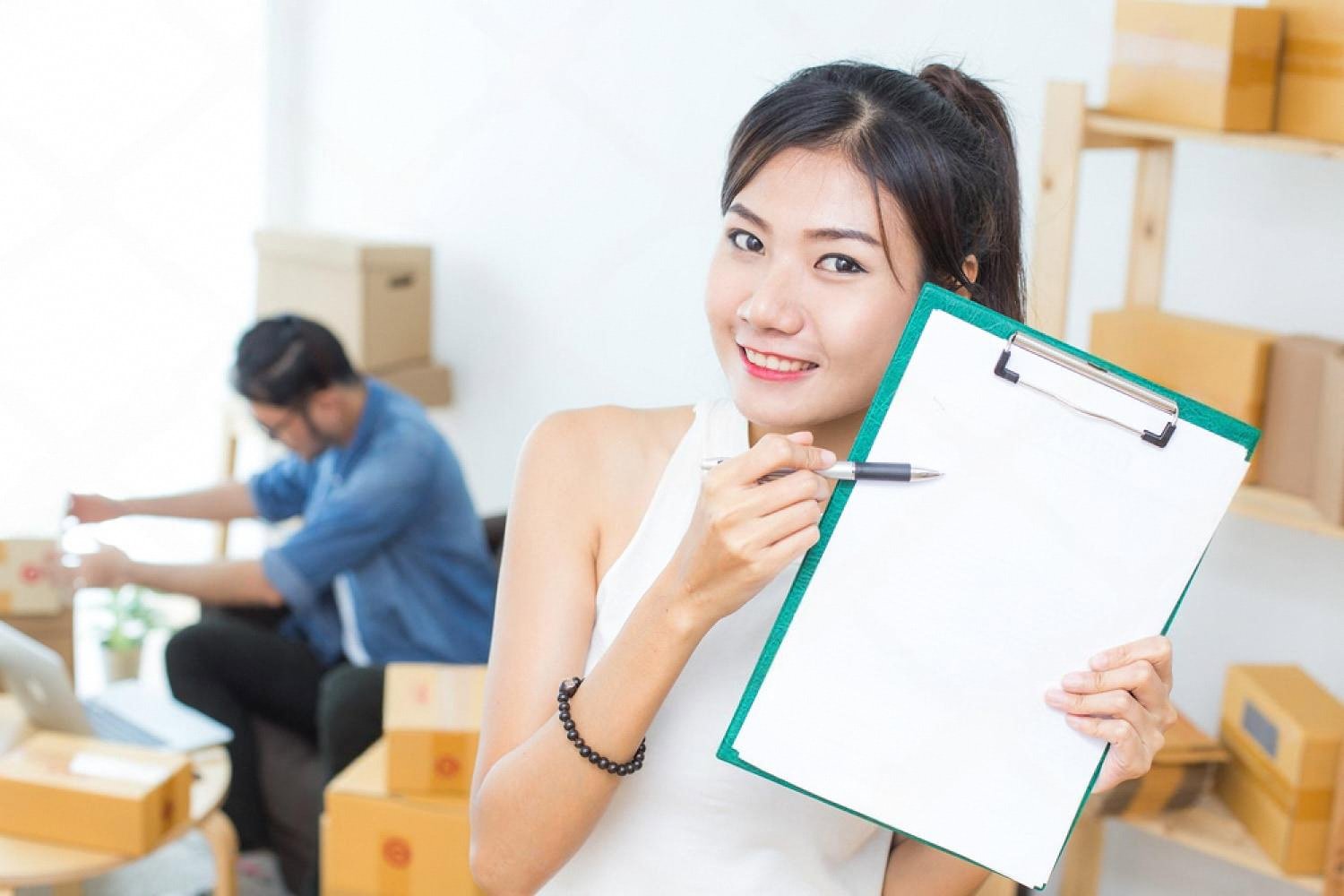 Business owner holding a clipboard while listing her rental company on UAE directories